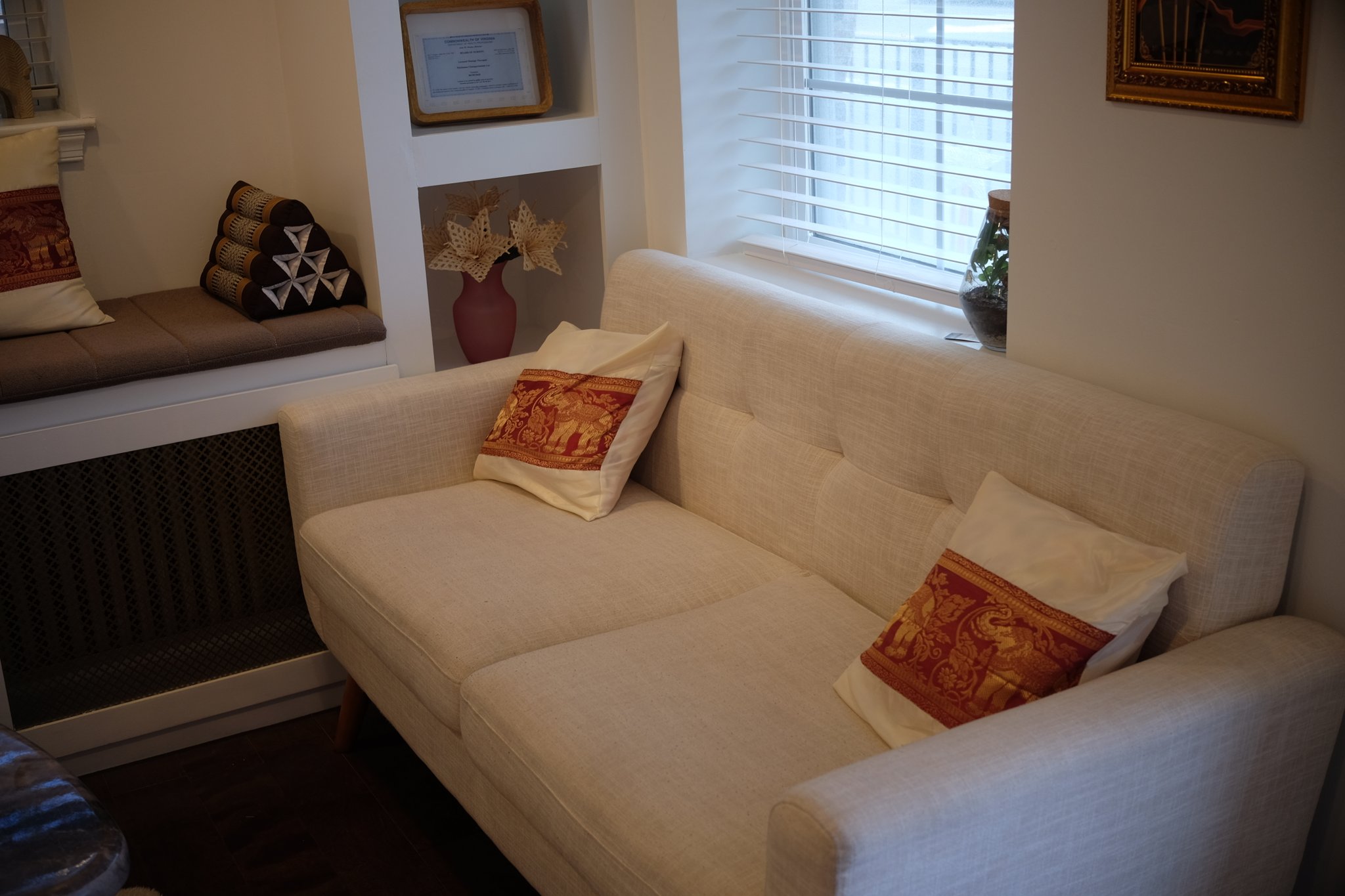 Serene treatment room with comfortable massage bed and peaceful ambiance at Bloom Thai Therapy