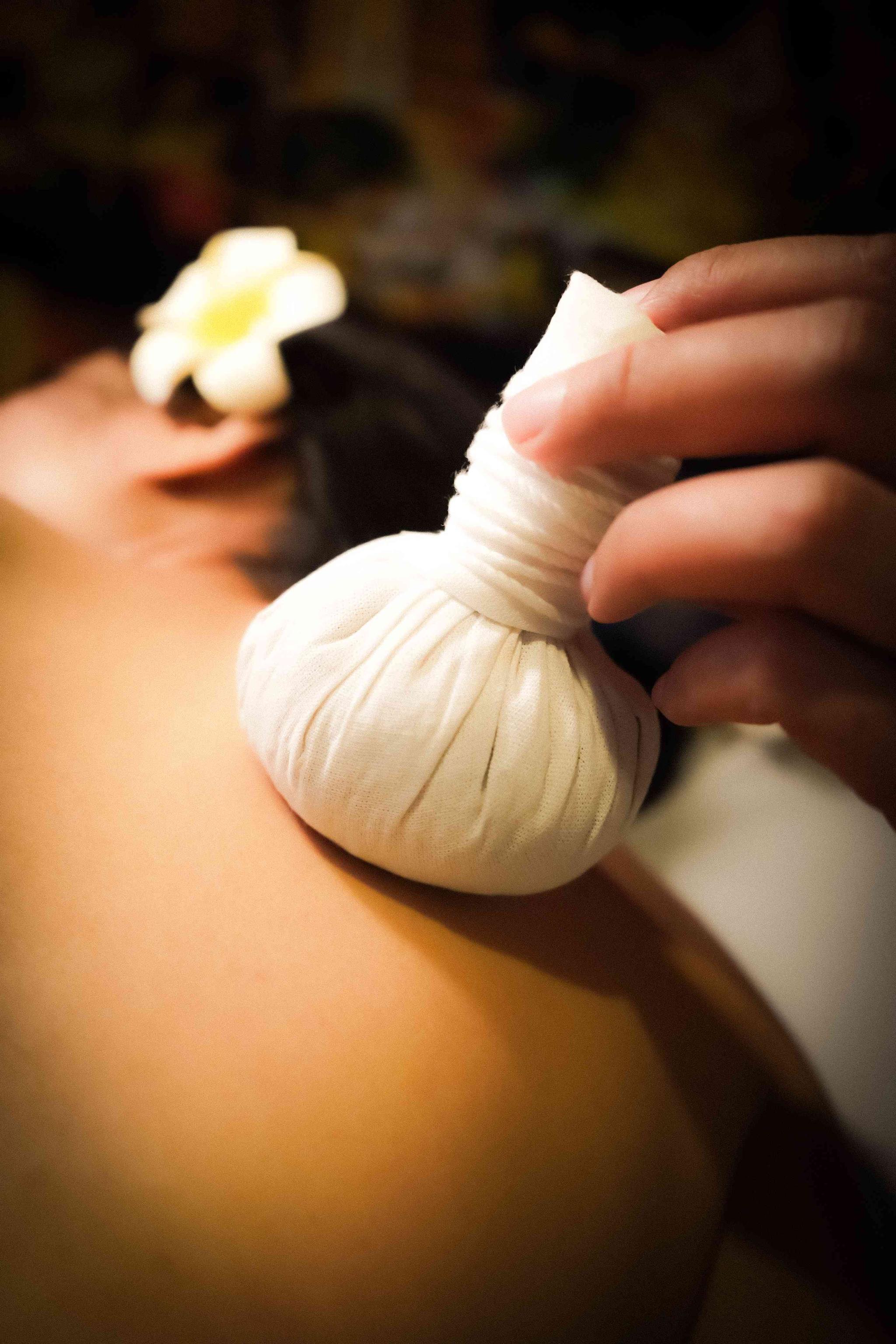 Herbal compress therapy session at Bloom Thai Therapy in Arlington VA for summer athletic recovery and muscle relief