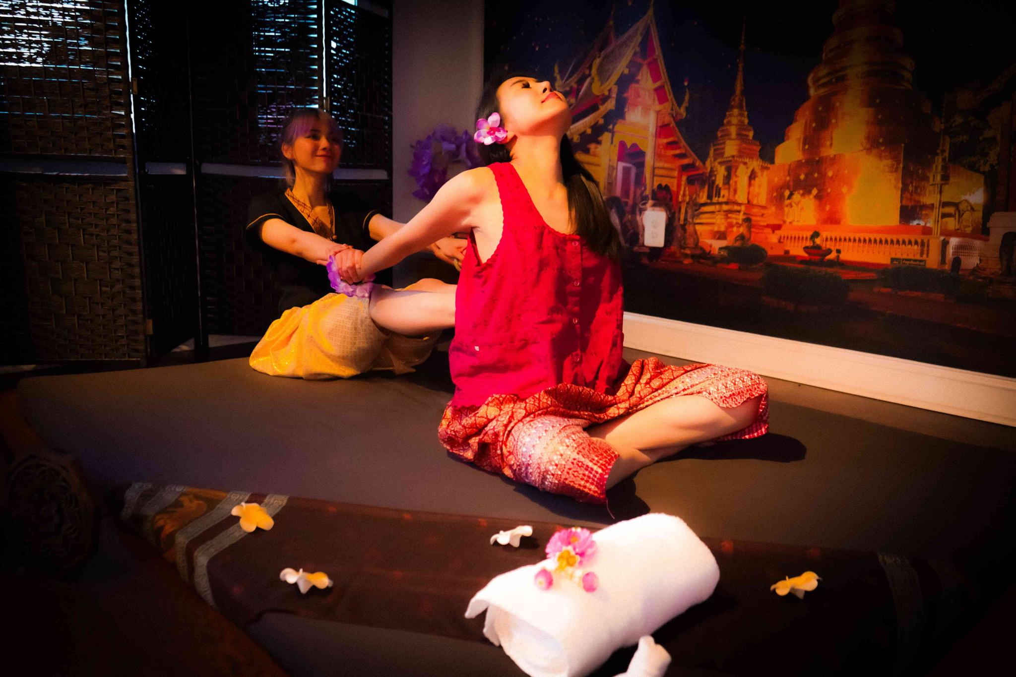 Traditional Thai massage therapist performing assisted stretching on a client at Bloom Thai Therapy in Arlington VA